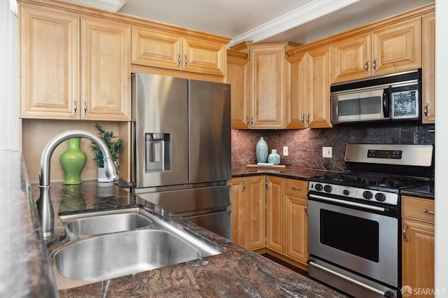 kitchen with sink, backsplash, appliances with stainless steel finishes, dark stone counters, and crown molding