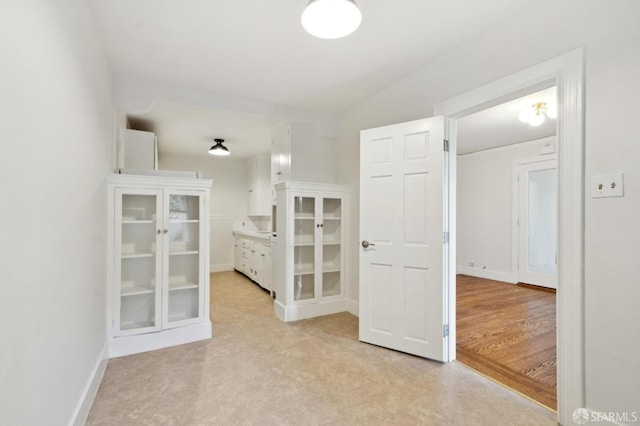 hallway featuring baseboards