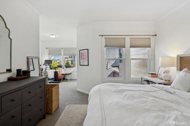 carpeted bedroom with crown molding and baseboards