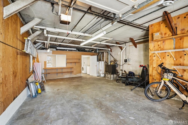 garage with water heater and a garage door opener