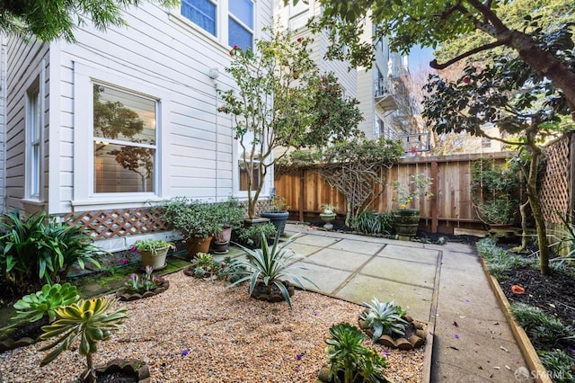 view of yard with fence and a patio