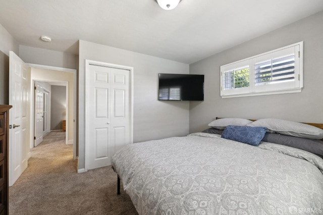 bedroom with light colored carpet and a closet