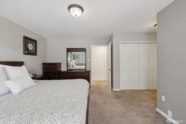 bedroom with a closet and light carpet