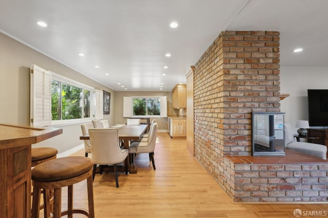 dining space with light hardwood / wood-style flooring