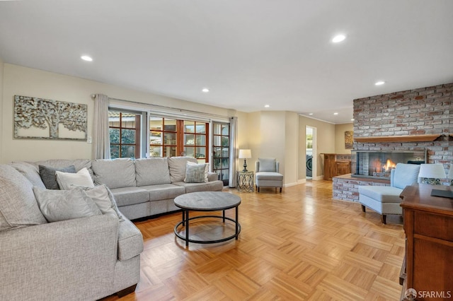 living room with light parquet floors and a brick fireplace