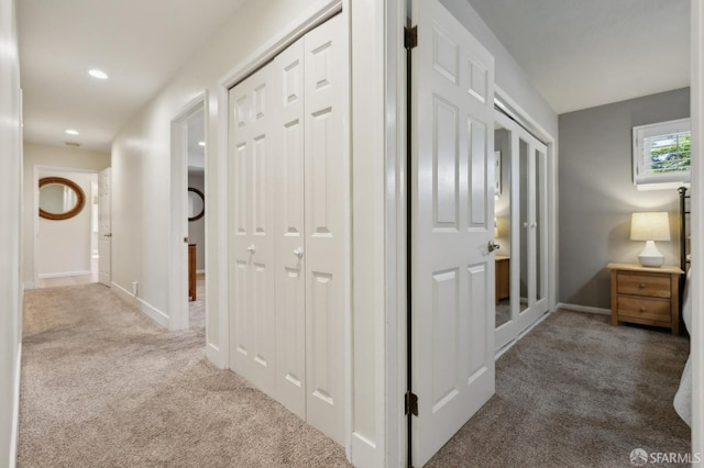 hall featuring light colored carpet