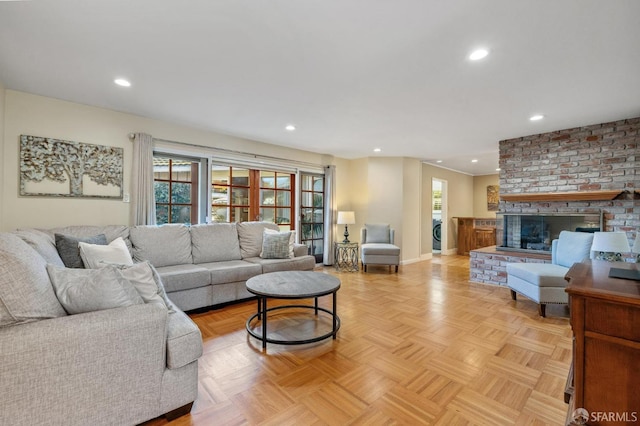 living room with light parquet flooring and a brick fireplace