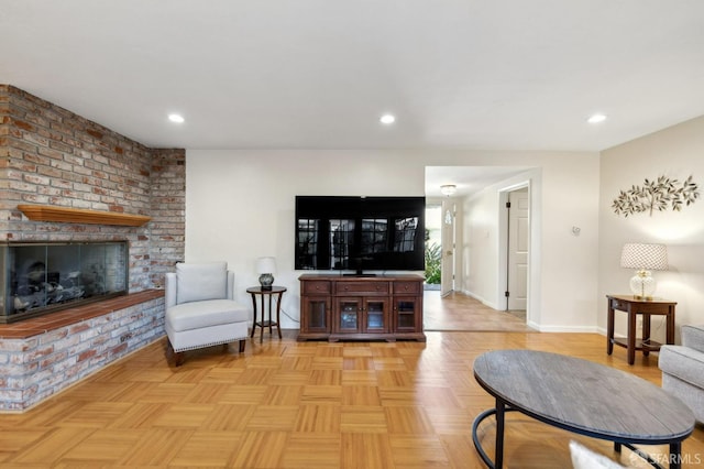 living room featuring light parquet flooring and a brick fireplace