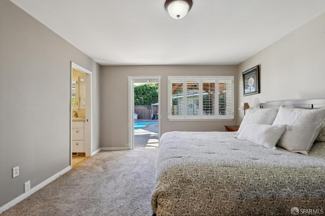 carpeted bedroom featuring access to outside and ensuite bathroom