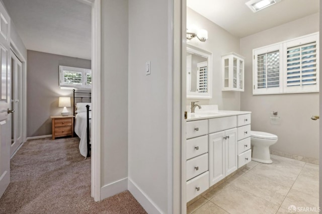 bathroom with vanity, tile patterned floors, and toilet