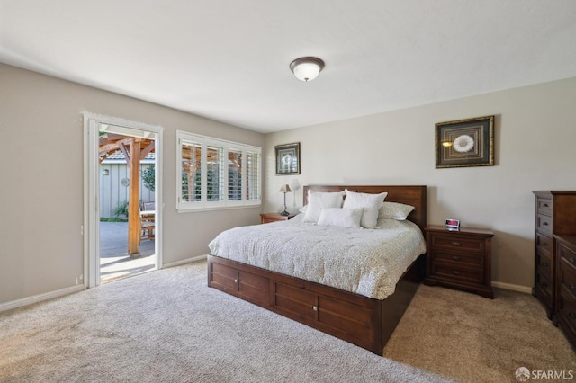 bedroom featuring light colored carpet and access to exterior