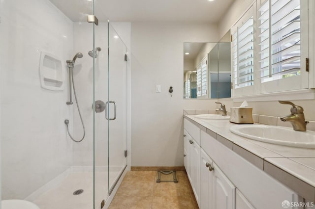 bathroom with vanity, tile patterned floors, and walk in shower