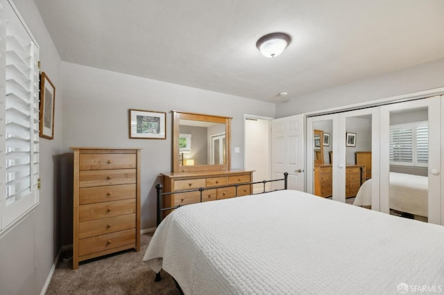 carpeted bedroom with french doors and a closet