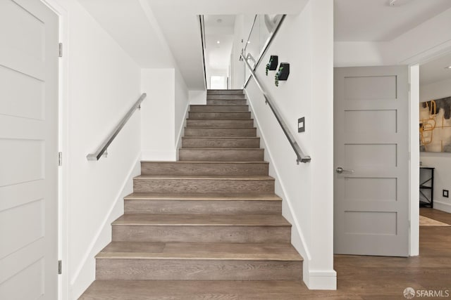 staircase featuring wood-type flooring