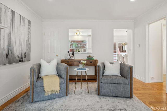 living area with baseboards, a chandelier, and crown molding