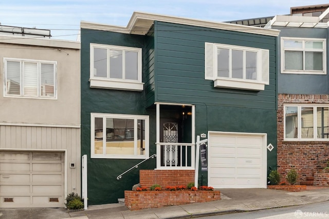 view of front of house with an attached garage and stucco siding