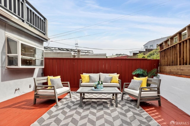 view of patio with outdoor lounge area, a fenced backyard, and a wooden deck