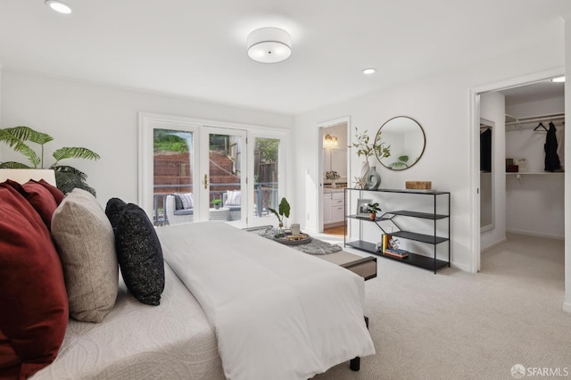 bedroom with recessed lighting, light carpet, baseboards, access to exterior, and a spacious closet