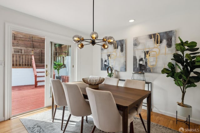 dining room featuring recessed lighting, a notable chandelier, baseboards, and wood finished floors