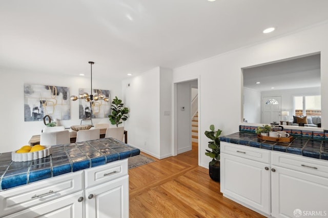 kitchen featuring a notable chandelier, recessed lighting, light wood-style flooring, and white cabinets