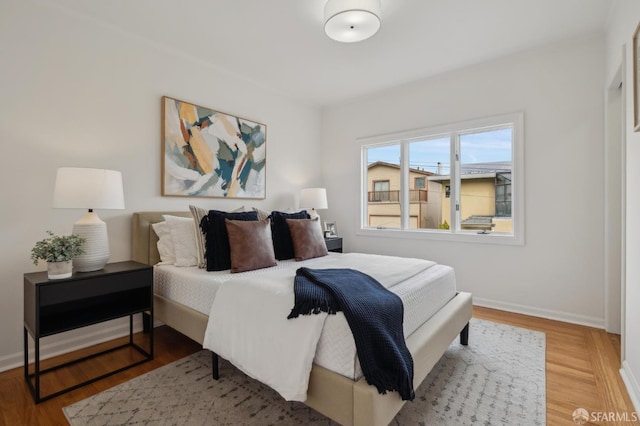 bedroom featuring wood finished floors and baseboards