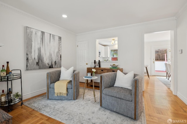 sitting room with ornamental molding, recessed lighting, and baseboards