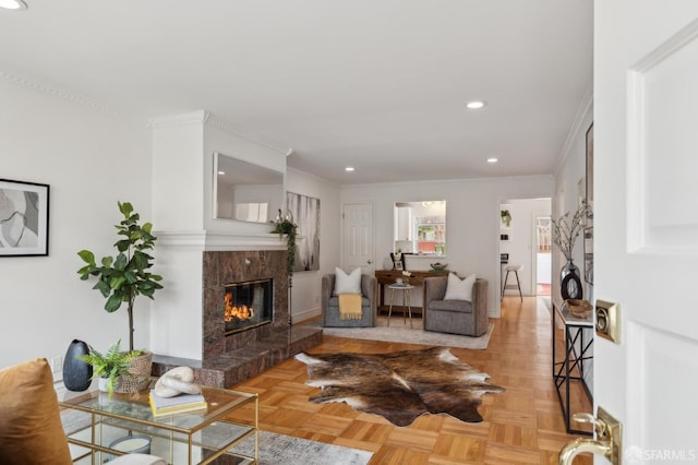 living room with recessed lighting, a fireplace, and crown molding