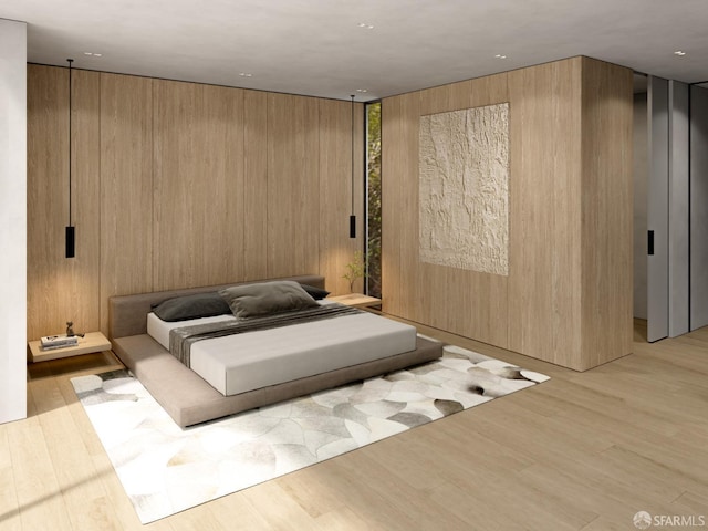 bedroom featuring wood walls and light hardwood / wood-style floors