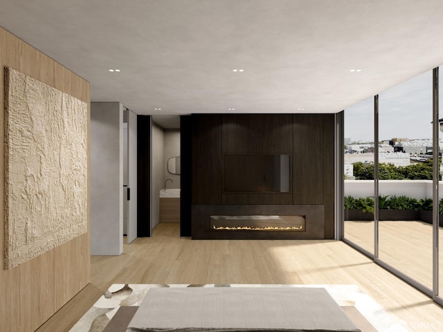 entryway featuring expansive windows, a fireplace, and light hardwood / wood-style flooring