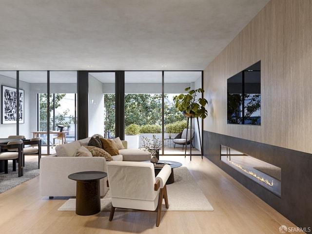 living room with expansive windows and light wood-type flooring