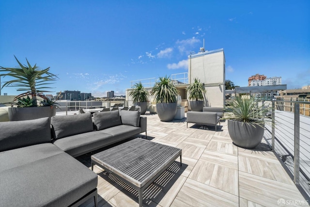 view of patio with an outdoor living space and a balcony