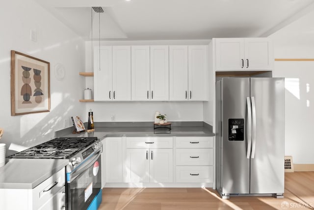 kitchen with light wood-style floors, white cabinetry, appliances with stainless steel finishes, and open shelves