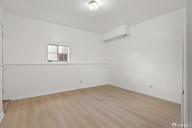spare room with light wood-style flooring and baseboards