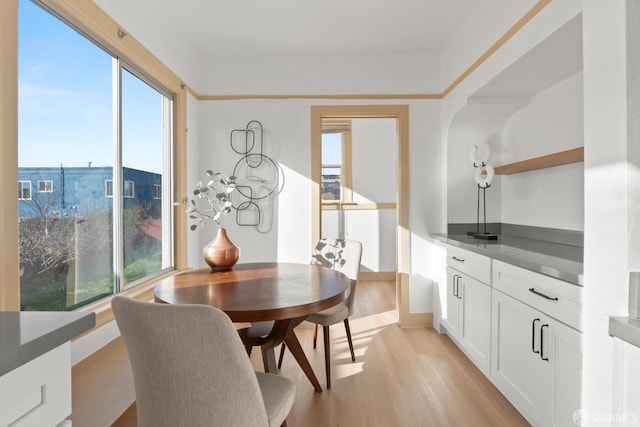 dining area with light wood-style floors and a wealth of natural light