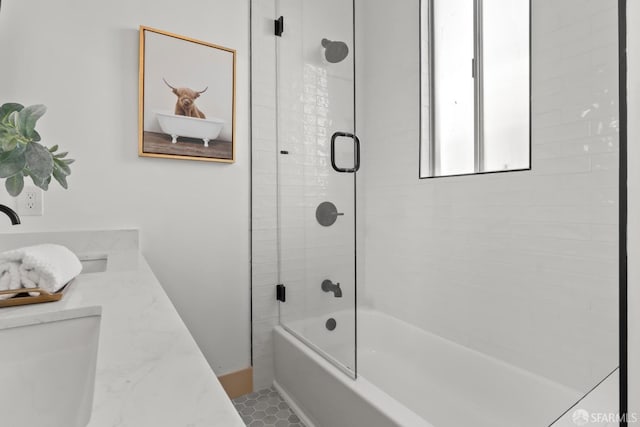 bathroom with bath / shower combo with glass door, a sink, and toilet