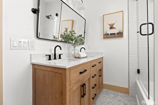 full bathroom with tile patterned flooring, a sink, baseboards, and double vanity