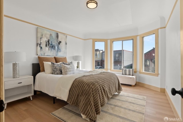 bedroom featuring wood finished floors and baseboards