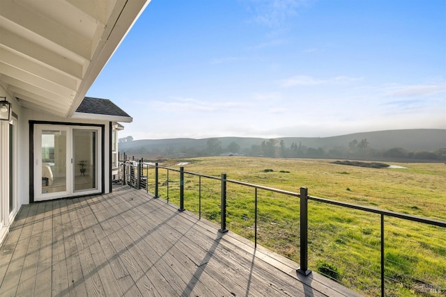 deck featuring a rural view and a mountain view