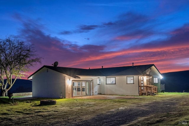 view of back house at dusk