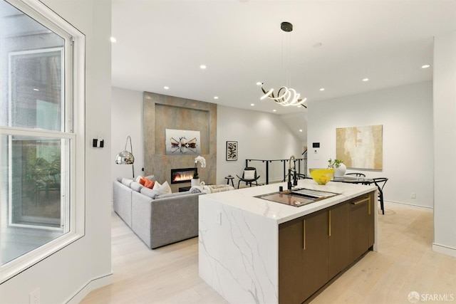 4038 18th St, San Francisco, CA 94114 - kitchen with a center island, recessed lighting, light wood-type flooring, a tile fireplace, and decorative light fixtures