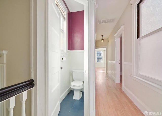 bathroom with hardwood / wood-style floors and toilet