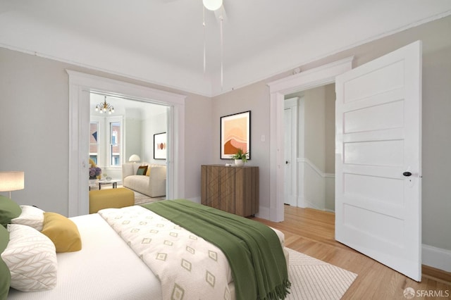 bedroom with ceiling fan and light wood-type flooring