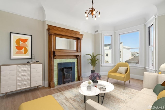 living room with a notable chandelier and light hardwood / wood-style floors