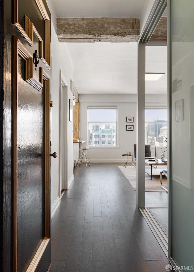 hallway with beam ceiling and dark wood-type flooring