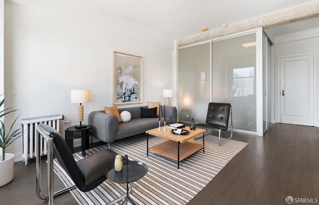 living room with dark hardwood / wood-style flooring