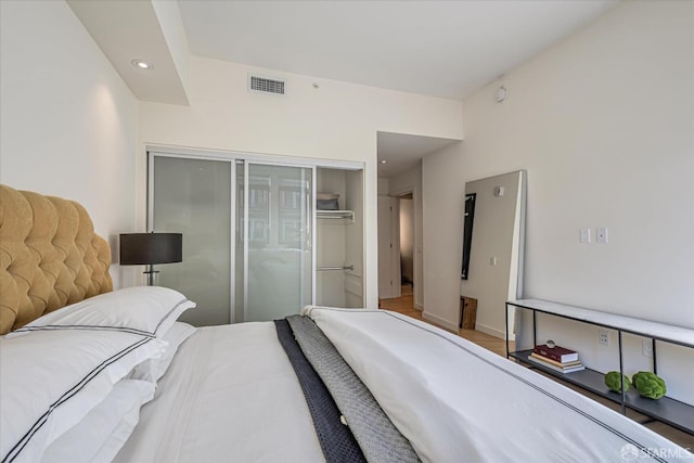 bedroom with a closet and hardwood / wood-style floors