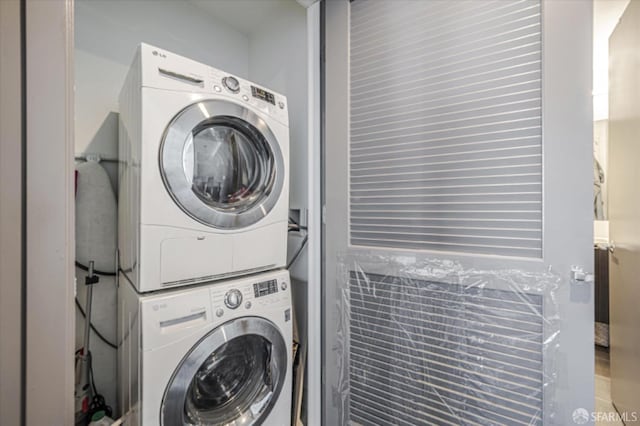 laundry room with stacked washer / dryer and laundry area