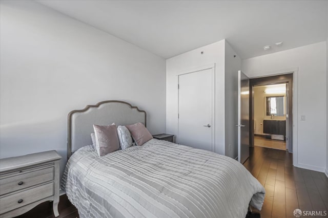 bedroom featuring dark wood-style floors and baseboards