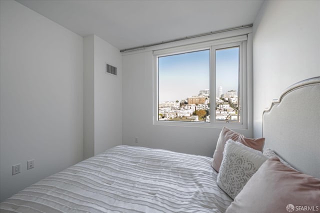 bedroom featuring a view of city and visible vents