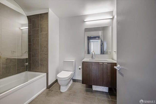 full bath with shower / bathing tub combination, toilet, vanity, baseboards, and tile patterned floors